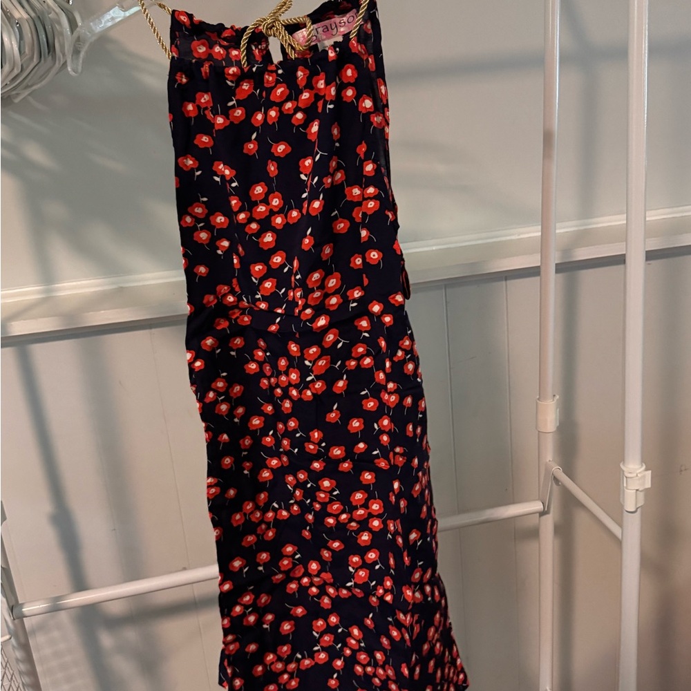 Navy dress with red/orange flowers with a gold tie at the top